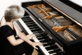 Piano player. Pianist woman playing grand piano