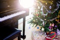 Piano and shine to Christmas tree for christmas holiday background.