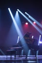 the piano on stage in the spotlight