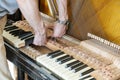 Piano tuning process. closeup of hand and tools of tuner working on grand piano. Detailed view of Upright Piano during a tuning. Royalty Free Stock Photo