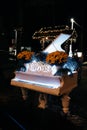 The piano was transformed into a waterfall as a restaurant decor with illumination decorated with flowers and greenery. night