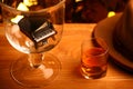 Piano whiskey glass vintage hat wooden table gold bokeh