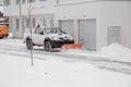 26.01.2021. Piaseczno. Poland. A pickup truck equipped with a plow is removing snow from a sloped driveway in winter