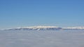 Piatra Craiului winter mountain ridge landscape, panoramic view from Poiana Brasov ski resort. Royalty Free Stock Photo