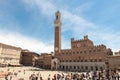 Town Hall Siena, Italy. Typical Renaissance palace at Piazza di Campo, Siena, Tuscany, Italy. Tourists visiting square.