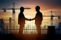 Pic Silhouette engineer and architect shaking hands on construction site Royalty Free Stock Photo