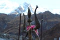 A closeup picture of trishula weapon of lord shiva, with a blurry Himalayan peak behind. Royalty Free Stock Photo