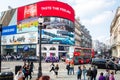 Piccadilly Circus in London busy traffic London red bus people a