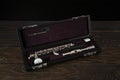 Piccolo flute in a case on a wooden surface Royalty Free Stock Photo
