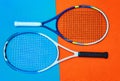 Pick anyone of the two. High angle shot of tennis essentials placed on top of a colourful background inside of a studio. Royalty Free Stock Photo