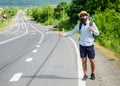 Pick me up. Hitchhiking one of cheapest ways traveling. Picking up hitchhikers. Hitchhikers risk being picked up by Royalty Free Stock Photo