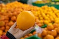 Pick orange, female hand pick up orange in supermarket. Royalty Free Stock Photo