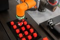 Pick and place robotic arm manipulator moving red toy blocks at robot exhibition