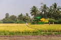 Pick thresher, in rice field behind mud, Ayodhya, Karnataka, India