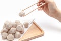 Pick up pork ball by chopsticks on white background isolated