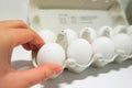 Pick up warm fresh white eggs fro box