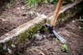 pickaxe in the garden, old kerbstone is dug up Royalty Free Stock Photo