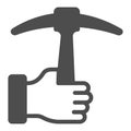 Pickaxe in hand solid icon, labour day concept, Tool for work with stone sign on white background, worker arm with