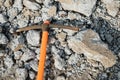 Pickaxe hoe lying on crushed stones. hand-held percussion tool designed for working on stone, stony ground, very dense ground