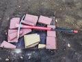 Pickaxe lies on the ground with pieces of paving slabs. Repair of sidewalks. Laying street tiles