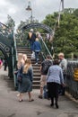 People passengers by the steps onto an old railway platform bridge at heritage railway