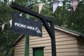 Retro Picnic Area sign showing directions on wooden pole gantry