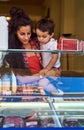 Picking a flavour. an attractive young woman and her young son at an ice cream shop.