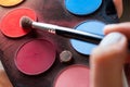 Picking the red color from the eyeshadow palette Royalty Free Stock Photo