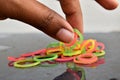 Picking rubber bands from a multi color rubber bands with fingers. Suitable picture for backgrounds and template use.