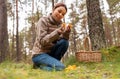 young woman picking mushrooms in autumn forest Royalty Free Stock Photo