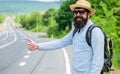 Picking up hitchhikers. Stop car. Man try stop car thumb up. Hitchhiking one of cheapest ways traveling. Hitchhikers Royalty Free Stock Photo