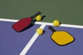 Pickleball - colorful paddles, ball and court
