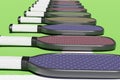 Pickleball different rackets lying in a line on a sports playground. Close up 3D rendering