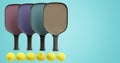 Pickleball multicolored rackets and balls in a row on an isolated background. 3d rendering