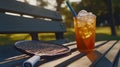 pickleball racket next to iced drink on bench . Royalty Free Stock Photo