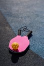 Pickleball rackets and a ball lying on court