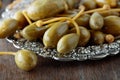 Pickled caper berries in metal dish