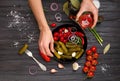 Plate with canned vegetables in hands on a dark background top view Royalty Free Stock Photo