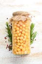 Pickled chickpeas in a glass jar. Turkish peas.