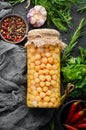 Pickled chickpeas in a glass jar. Turkish peas.