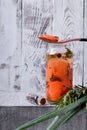 Pickled chopped carrots in a glass jar