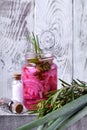 Pickled chopped red onion in a glass jar