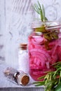 Pickled chopped red onion in a glass jar