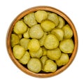 Pickled cucumber discs, known as pickle or gherkin, in wooden bowl Royalty Free Stock Photo