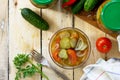 Pickled cucumber salad with tomatoes on the kitchen wooden background. Homemade pickle. Royalty Free Stock Photo