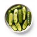 pickled cucumbers in a bowl on a white background