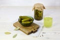 Pickled cucumbers in a bowl and jar, pickle juice in glass. Homemade marinated gherkins Royalty Free Stock Photo