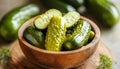 Pickled cucumbers in bowl on wooden rustic board Royalty Free Stock Photo