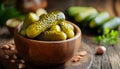 Pickled cucumbers in bowl on wooden rustic board Royalty Free Stock Photo