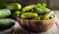 Pickled cucumbers in bowl on wooden rustic board Royalty Free Stock Photo